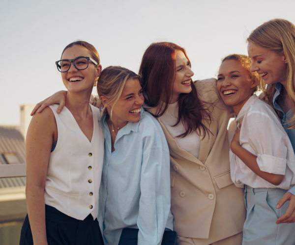 Laughing women embracing on city rooftop together 2026 03 24 12 59 39 utc