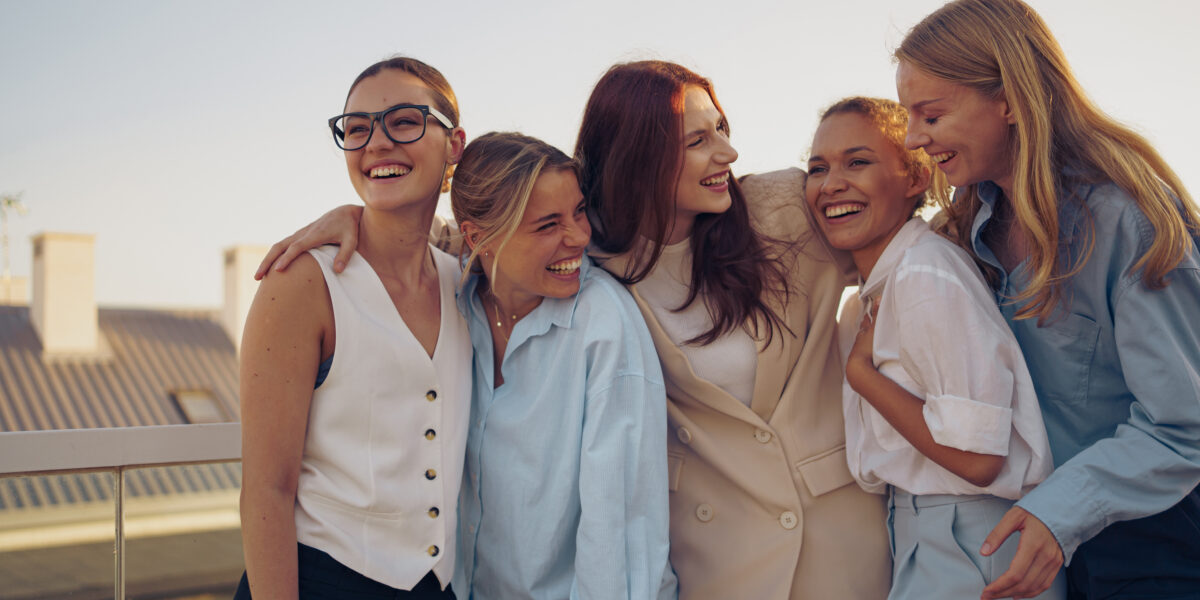 Laughing women embracing on city rooftop together 2026 03 24 12 59 39 utc