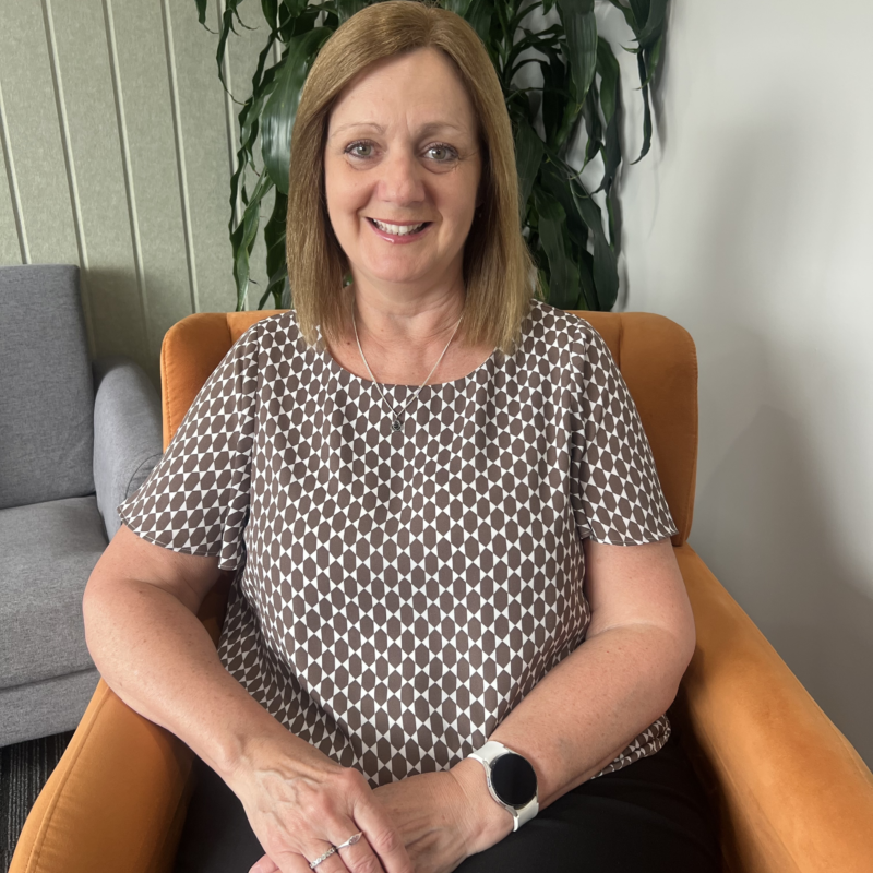 Karen Hutchinson seated